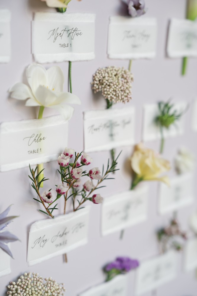 Vivian and Josen’s romantic destination wedding at Trisara Phuket — close flower-adorned escort-card detail